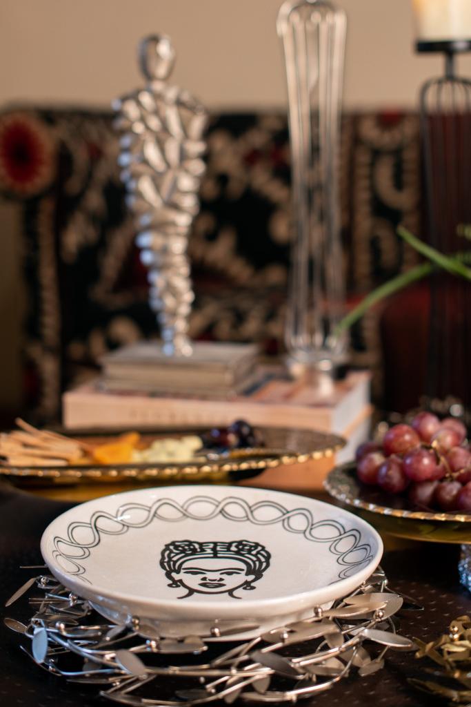 Image of Frida Forever Platter stoneware platter from august.org.in with metal riser and sculpture in the background
