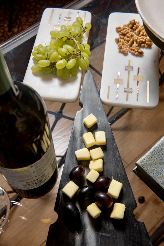 Image of Composite Cheese marble Platter from august.org.in with cheese and wine bottle