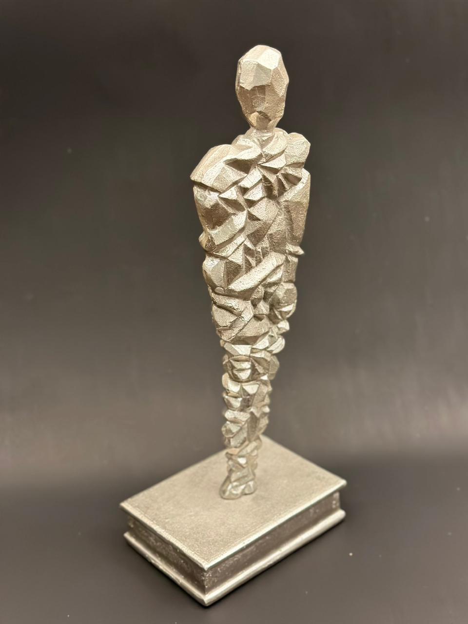 Image of Cleo (in silver) sculpture from august.org.in