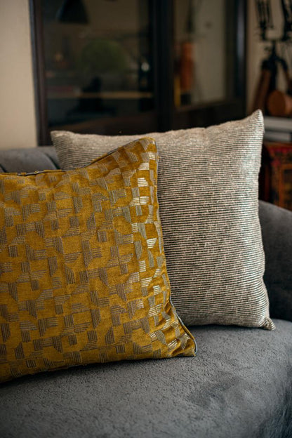 Image of gold dust cushion from august.org.in with another cushion on couch