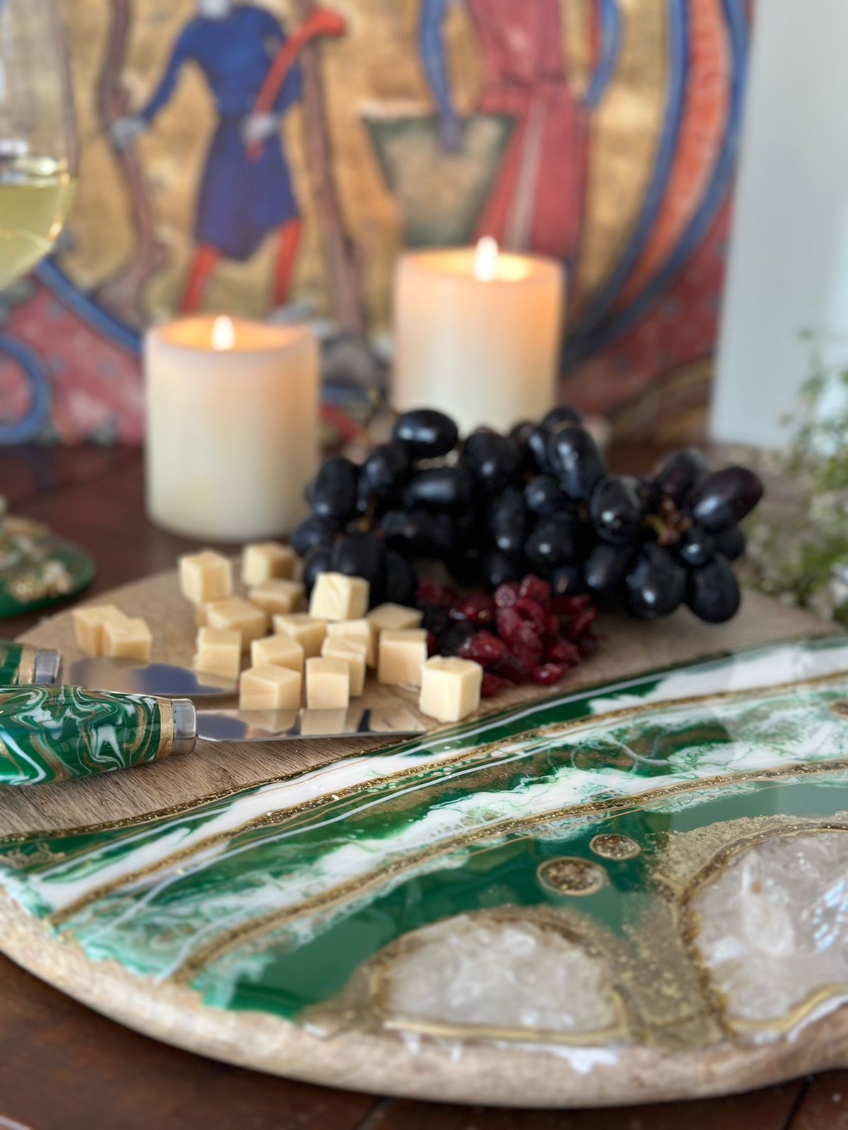 Round Cheese resin board green with food and candles in the background