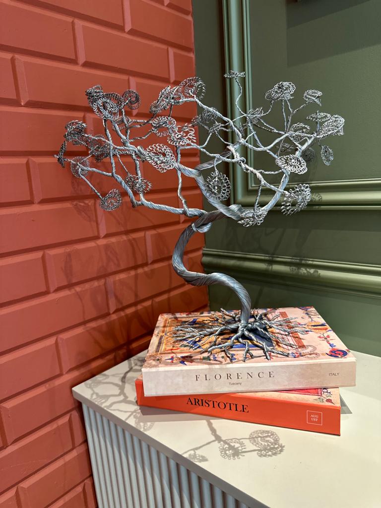 Image of metal tree with Book Cases from August.org.in